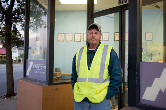 Man in safety vest outside In Every Story office