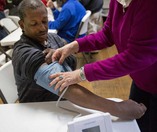 Man has his blood pressure checked at the Triune Mercy Center