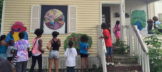 Children admiring a mural they painted