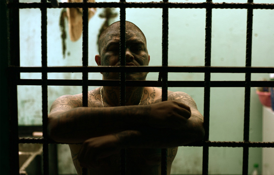 Tattooed man in a jail cell